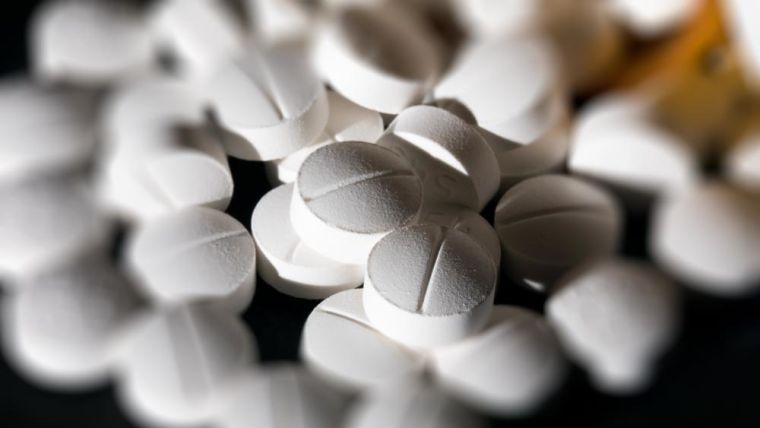 Close-up of a pile of round white tablets