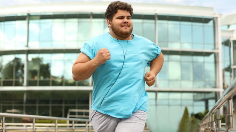 Overweight man jogging outside