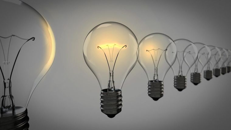 Light bulbs in a row with beige background - representing new ideas